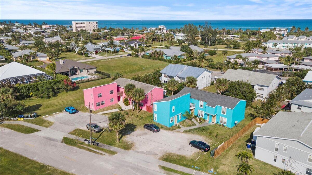 An aerial view shows two brightly colored pink and turquoise multi-unit buildings near the coast — 646 Eldorado Street, Fort Pierce FL 34949, FORT PIERCE, FL