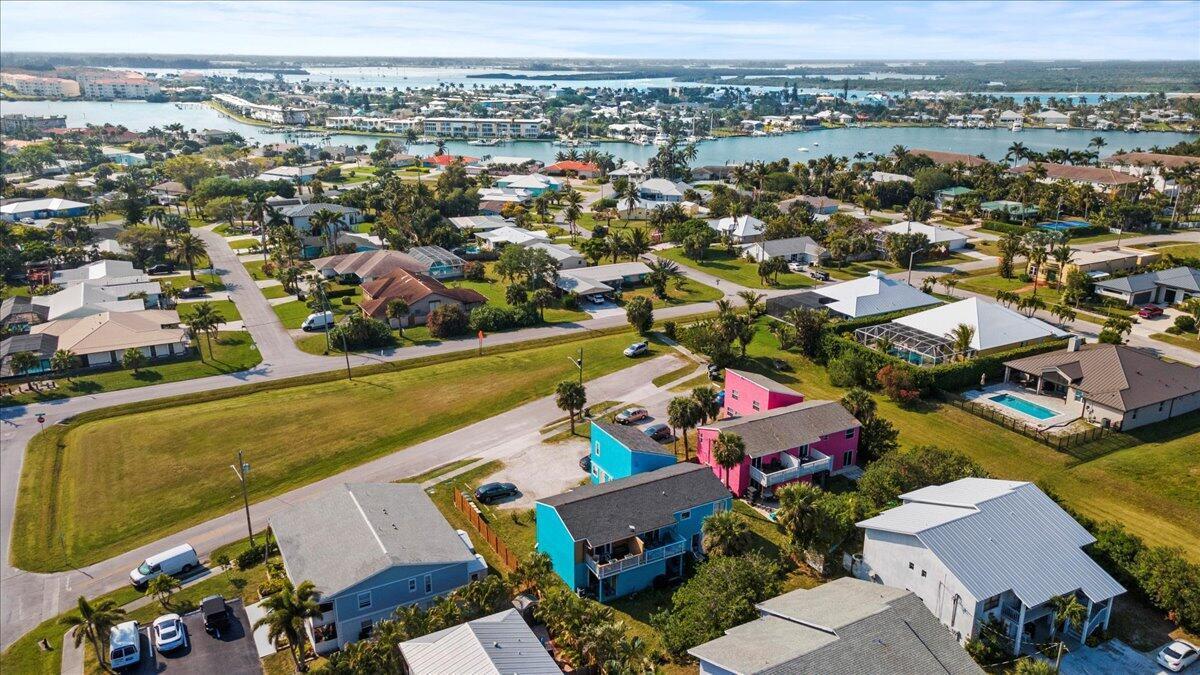 An aerial view shows a residential neighborhood with colorful houses near a coastal waterway — 646 Eldorado Street, Fort Pierce FL 34949, FORT PIERCE, FL