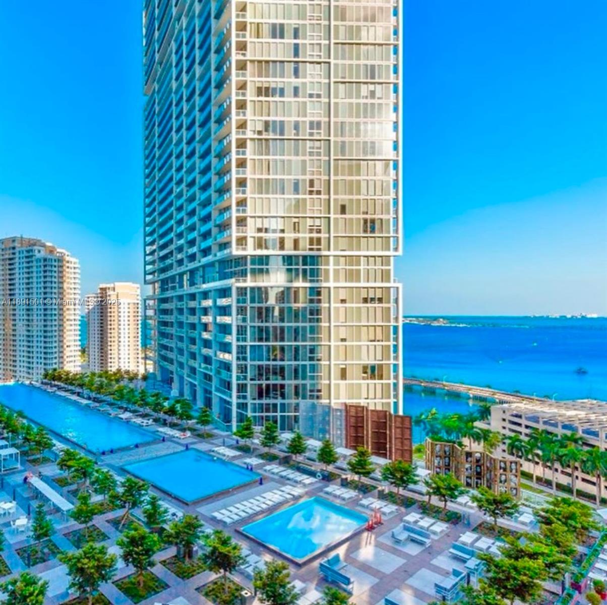 An aerial view shows a tall residential building with multiple swimming pools and landscaped terraces — 495 Brickell Ave # 3706, Miami FL 33131, MIAMI, FL