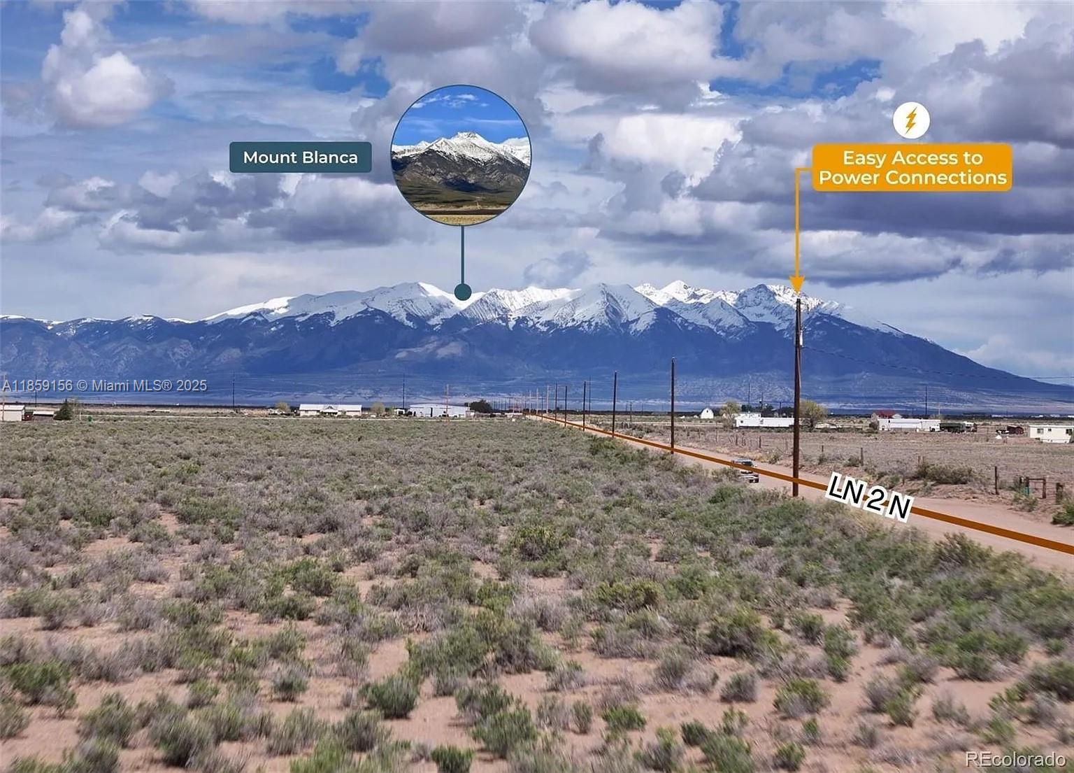 A rural landscape features desert vegetation, utility poles, and a view of snow-capped mountains — 10 N 2 Lane, CO 81146, CO