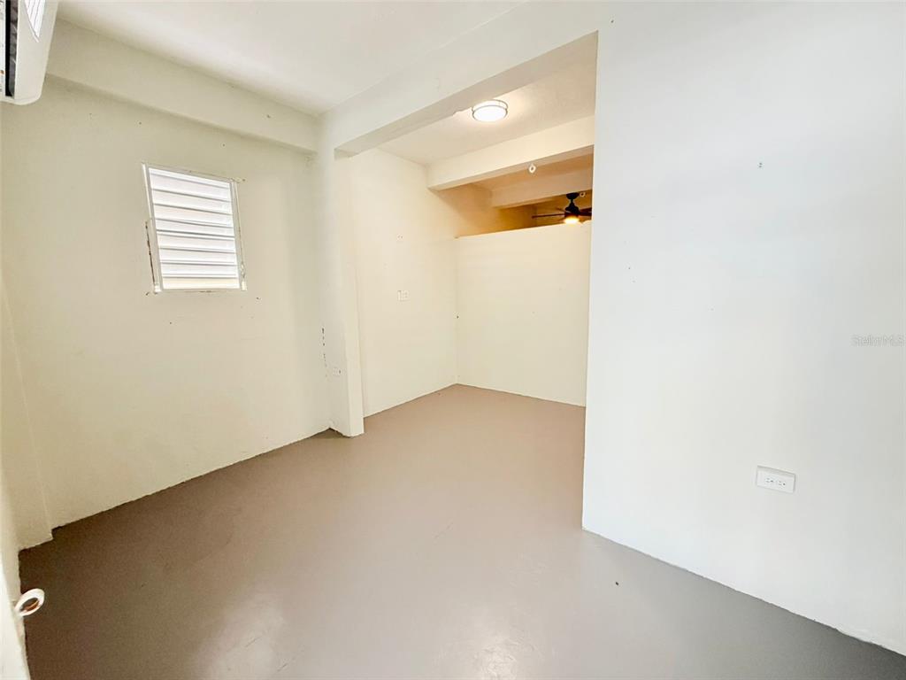 An empty room with white walls, a gray floor, and a small louvered window — 0 LIPPITT, SAN JUAN, PR
