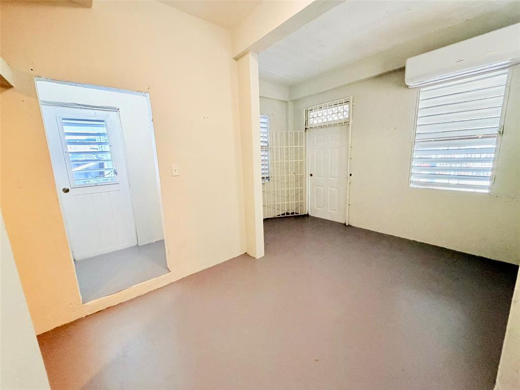 An interior room with light-colored walls, a gray floor, two doors, and a window — 0 LIPPITT, SAN JUAN, PR