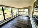 A sunroom with dark wood flooring and large windows overlooking a grassy yard — 2507 CORAL WAY, LAKELAND, FL