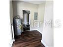 A utility closet contains a water heater, an electrical panel, and dark wood-look flooring — 2507 CORAL WAY, LAKELAND, FL