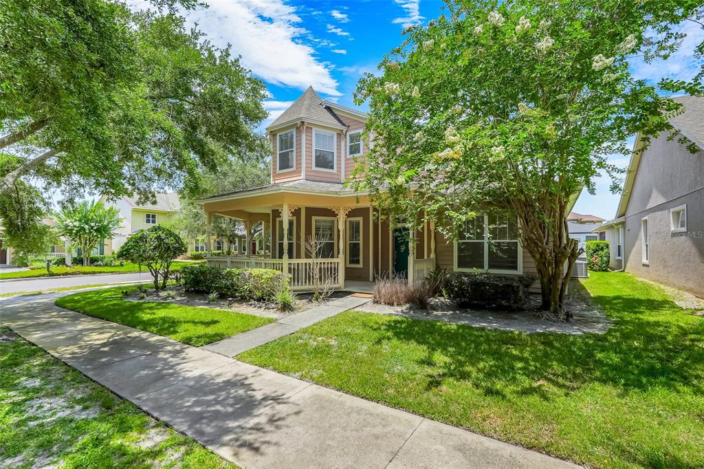 A two-story house with a wrap-around porch, turret, and a sidewalk in the front yard — 6601 DUNCASTER STREET, WINDERMERE, FL