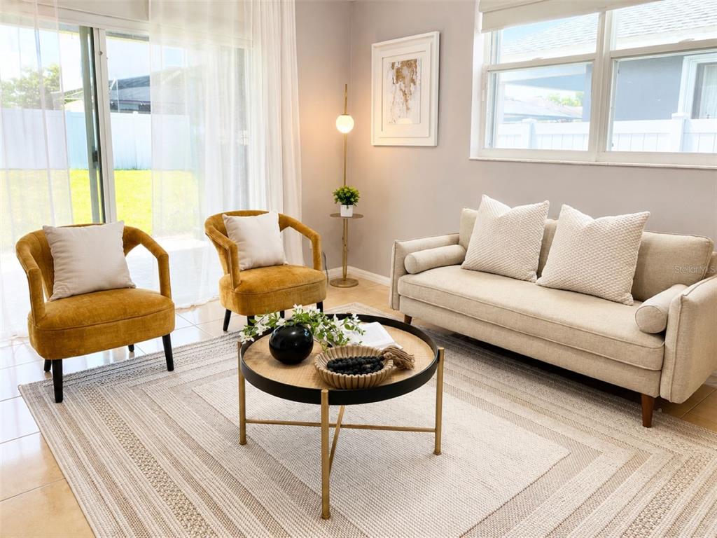A living room features two mustard yellow chairs, a beige sofa, and a round coffee table — 10209 ANDOVER POINT CIRCLE, ORLANDO, FL