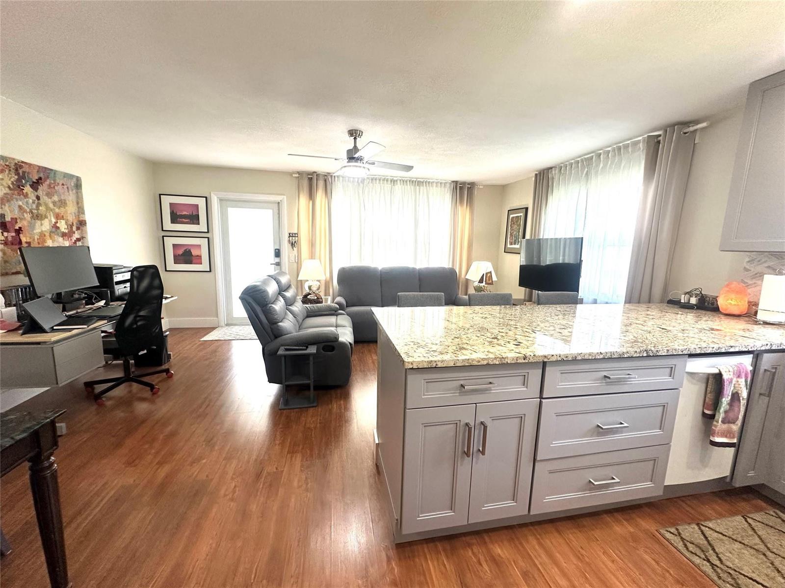 An open-concept living area features a kitchen island, a home office, and a seating area — 528 Tilford X # 528, Deerfield Beach FL 33442, DEERFIELD BEACH, FL