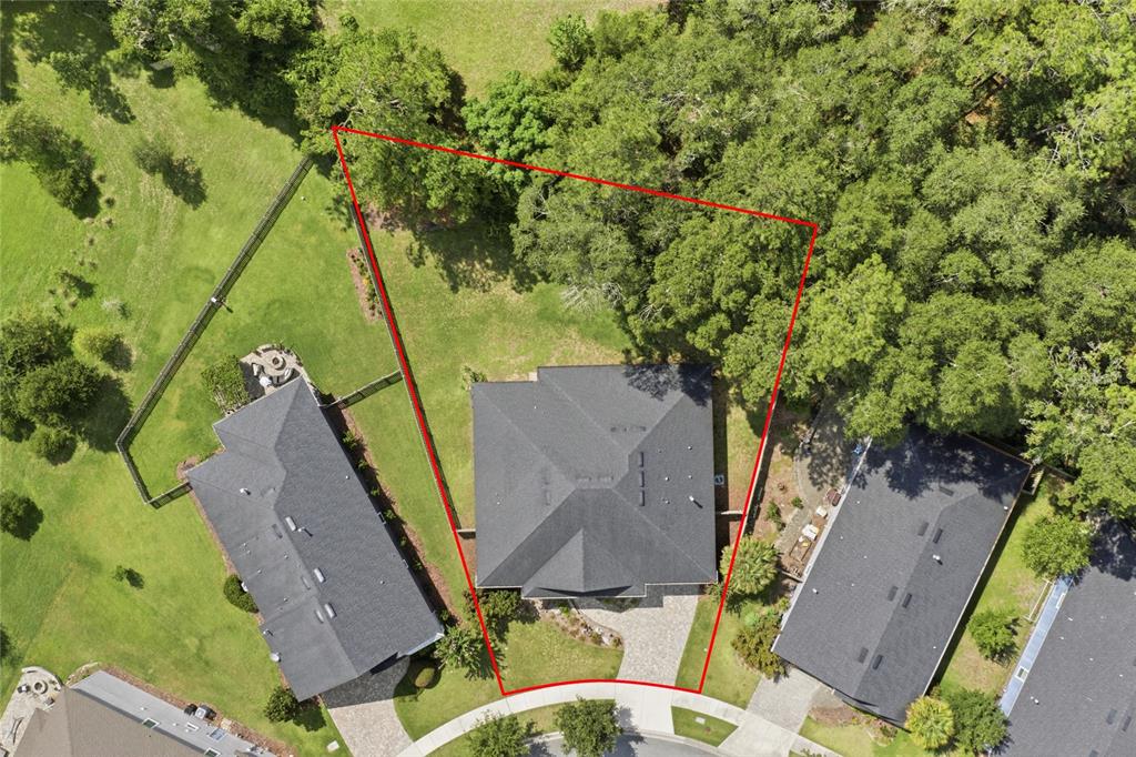 An aerial view shows a house with a dark roof on a trapezoidal lot — 13417 NW 10TH LANE, NEWBERRY, FL