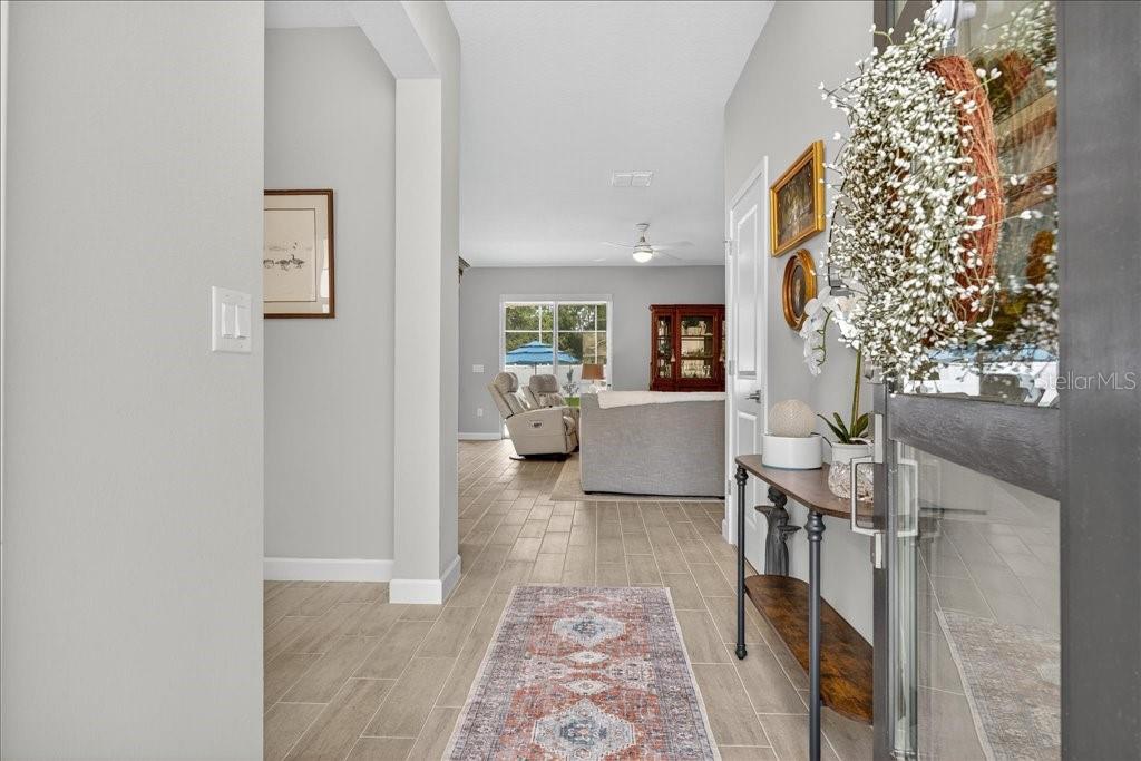 A view from an entryway looking into a living room with light tile flooring — 44 BOULDER ROCK DRIVE, PALM COAST, FL