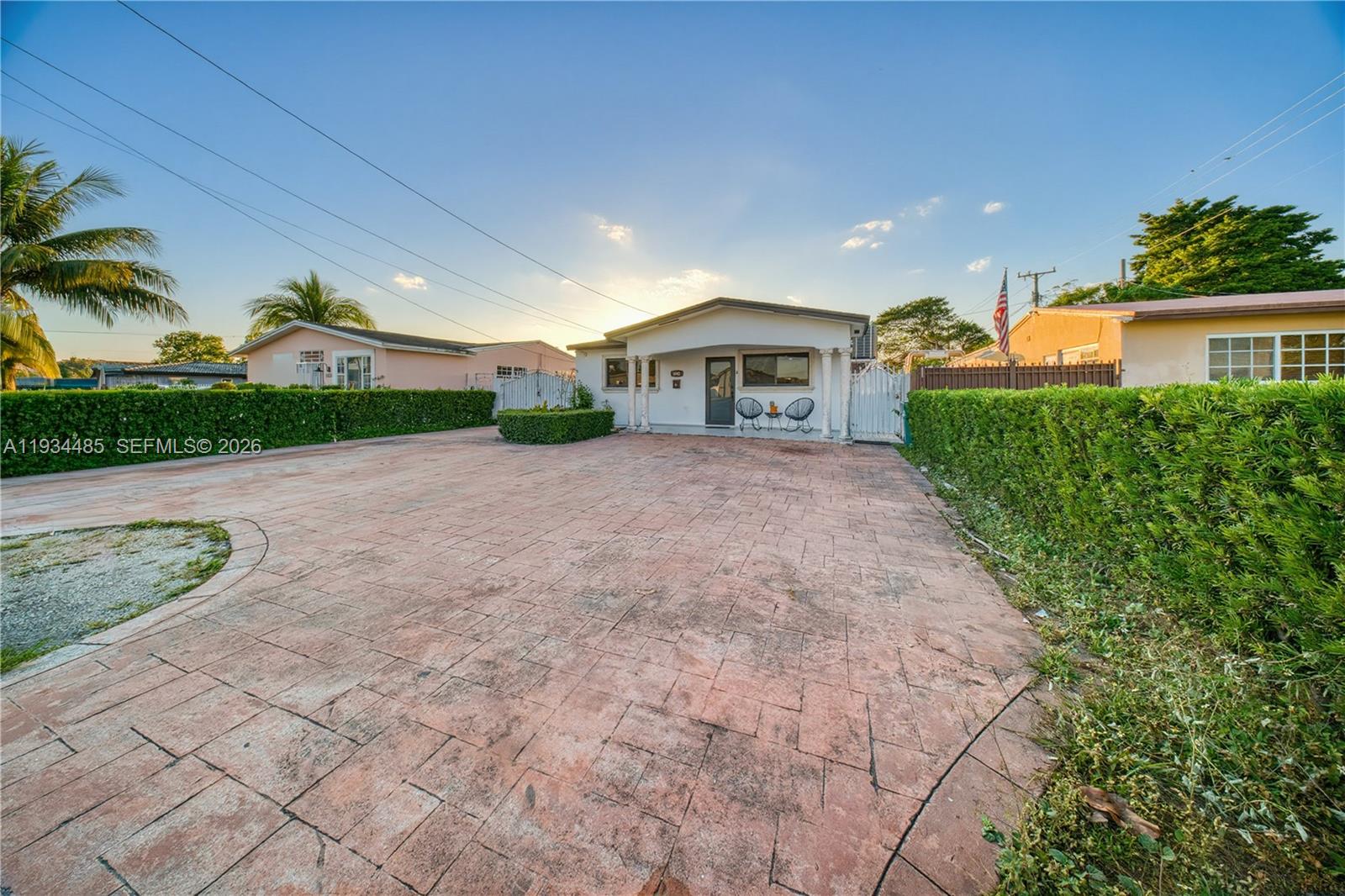 A single-story house with a paved driveway and a tall hedge-lined front yard — 3640 SW 92nd Ave, Miami FL 33165, MIAMI, FL