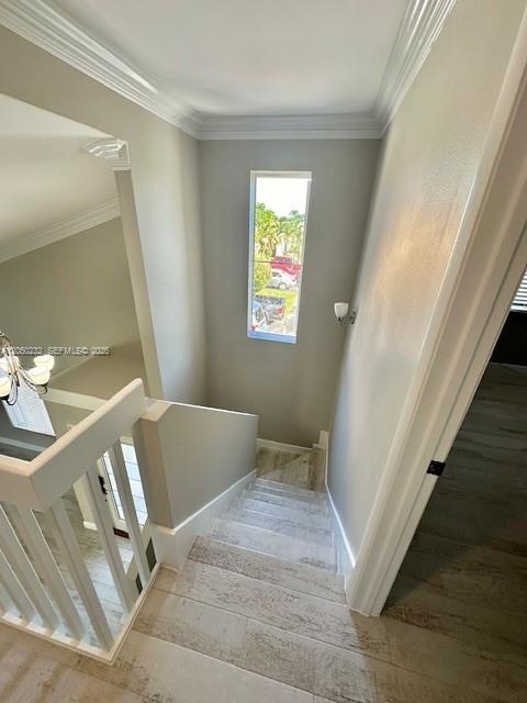 A staircase with light wood-look tile flooring leads down past a tall window — 19853 NW 64th Pl, Hialeah FL 33015, HIALEAH, FL