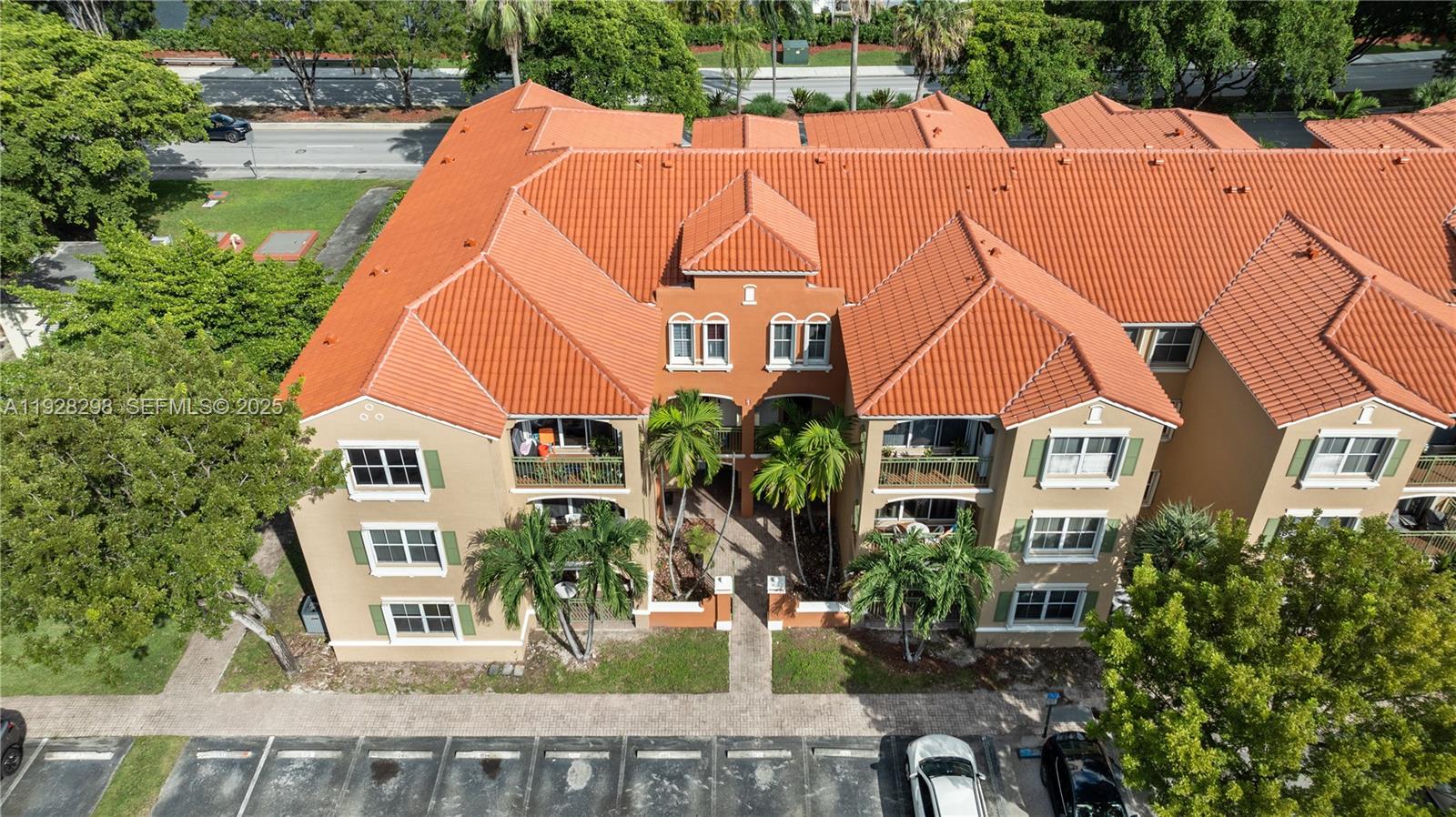 An aerial view shows a multi-story apartment building with a terracotta tile roof — 6500 NW 114th Ave # 1032, Doral FL 33178, DORAL, FL