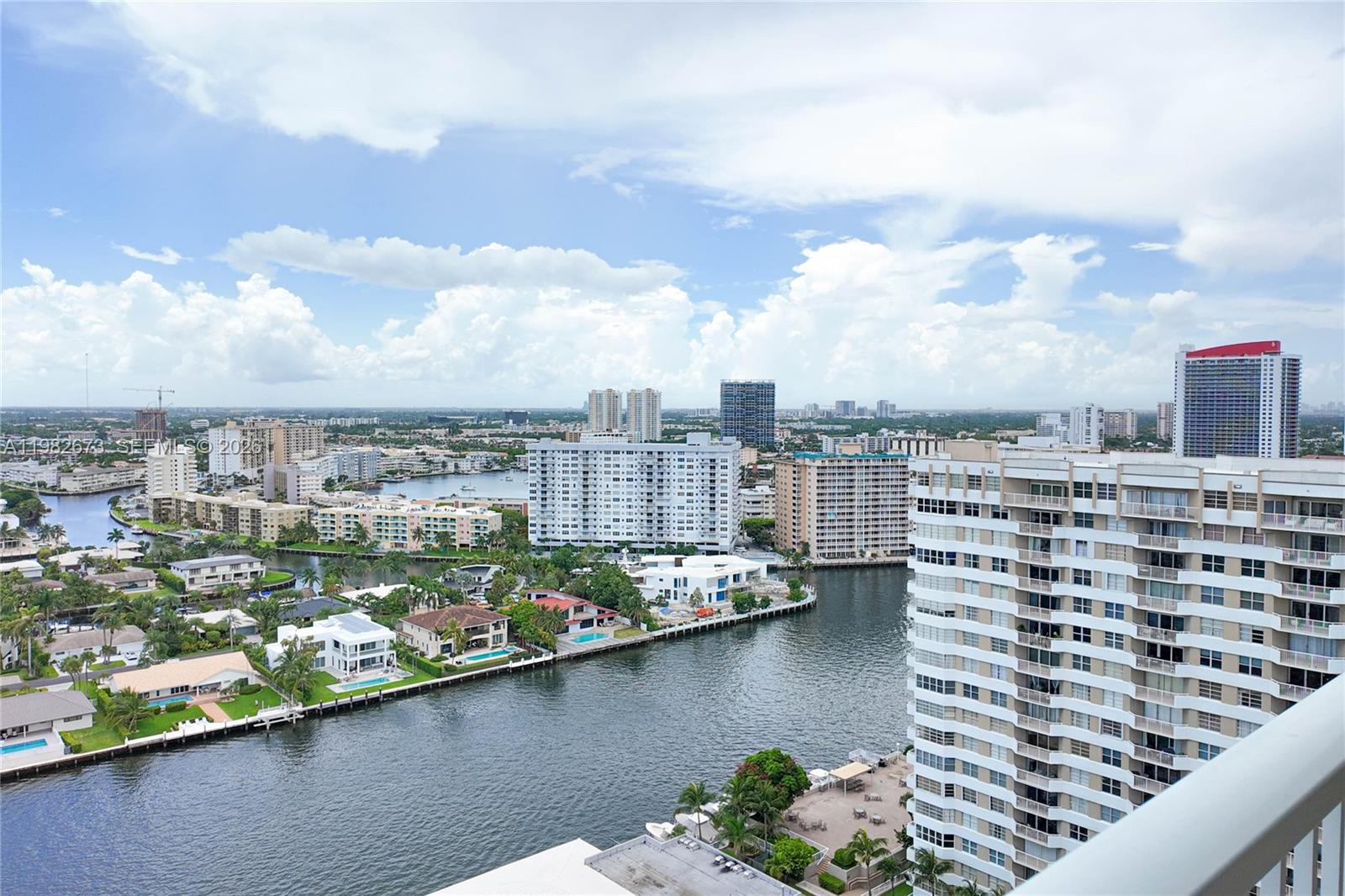 An elevated view shows a waterway winding through a dense residential area with high-rise buildings — 1985 S Ocean Dr # 22E, Hallandale Beach FL 33009, HALLANDALE BEACH, FL