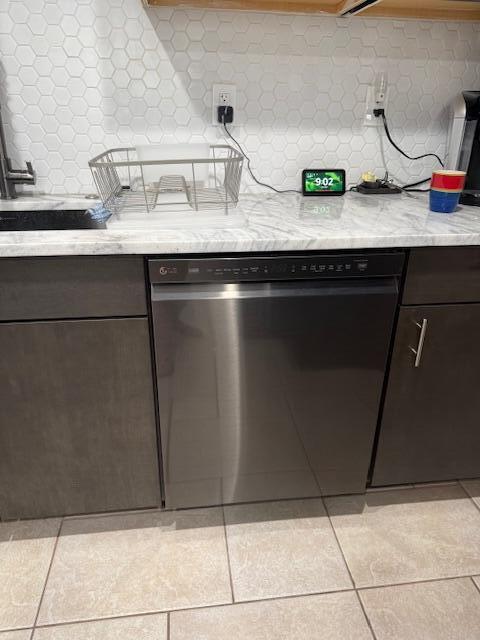 A stainless steel dishwasher is installed under a marble countertop in a modern kitchen — 99 Capri C # 99, Delray Beach FL 33484, DELRAY BEACH, FL