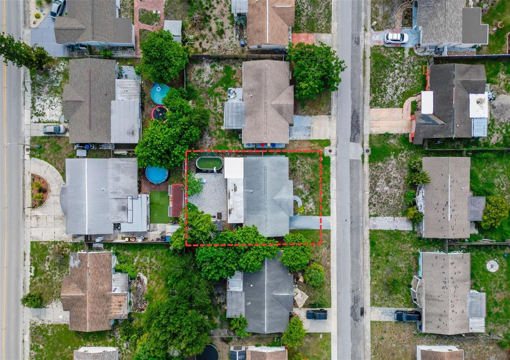 An aerial view shows a residential property outlined in red, surrounded by neighboring houses — 3049 KILBURN ROAD, HOLIDAY, FL