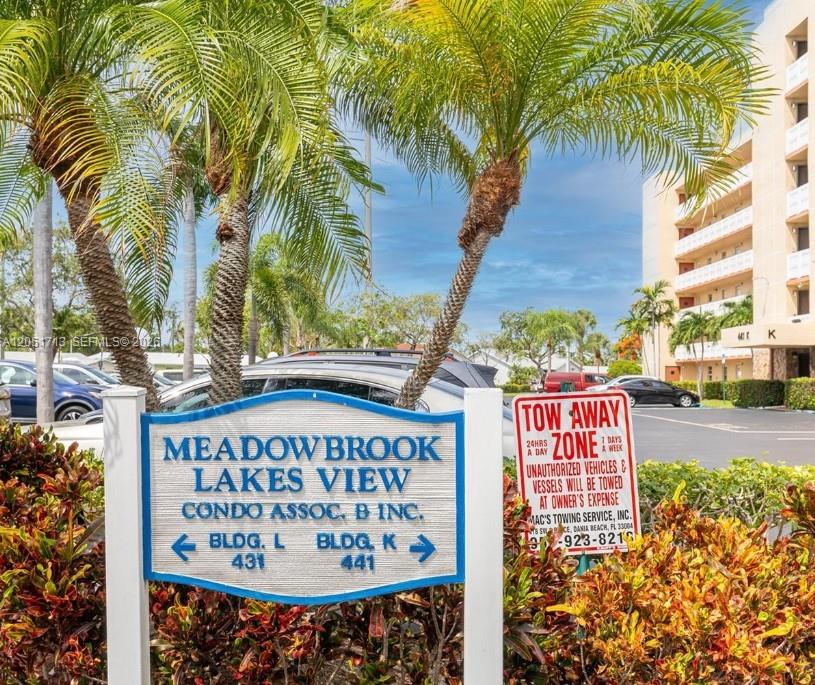 A sign for Meadowbrook Lakes View condo association stands in front of palm trees — 441 SE 3rd St # 505, Dania Beach FL 33004, DANIA BEACH, FL