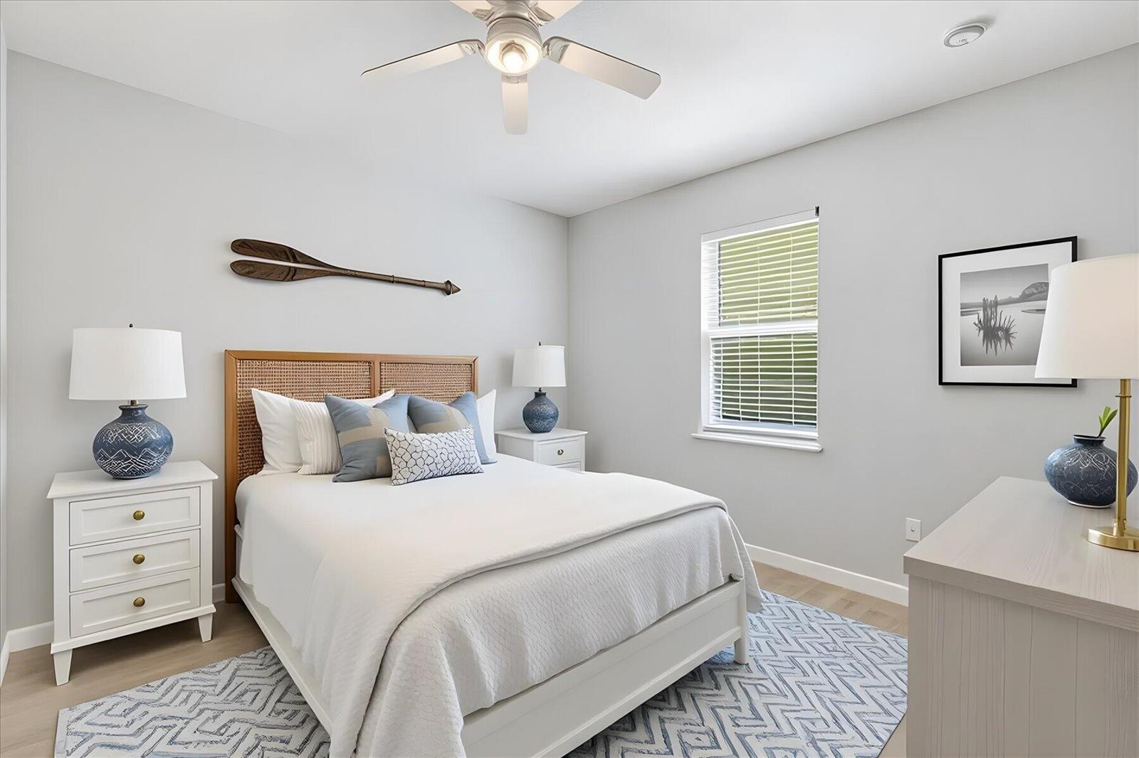 A bedroom features a bed with a rattan headboard, two nightstands, and a patterned rug — VERO BEACH, FL