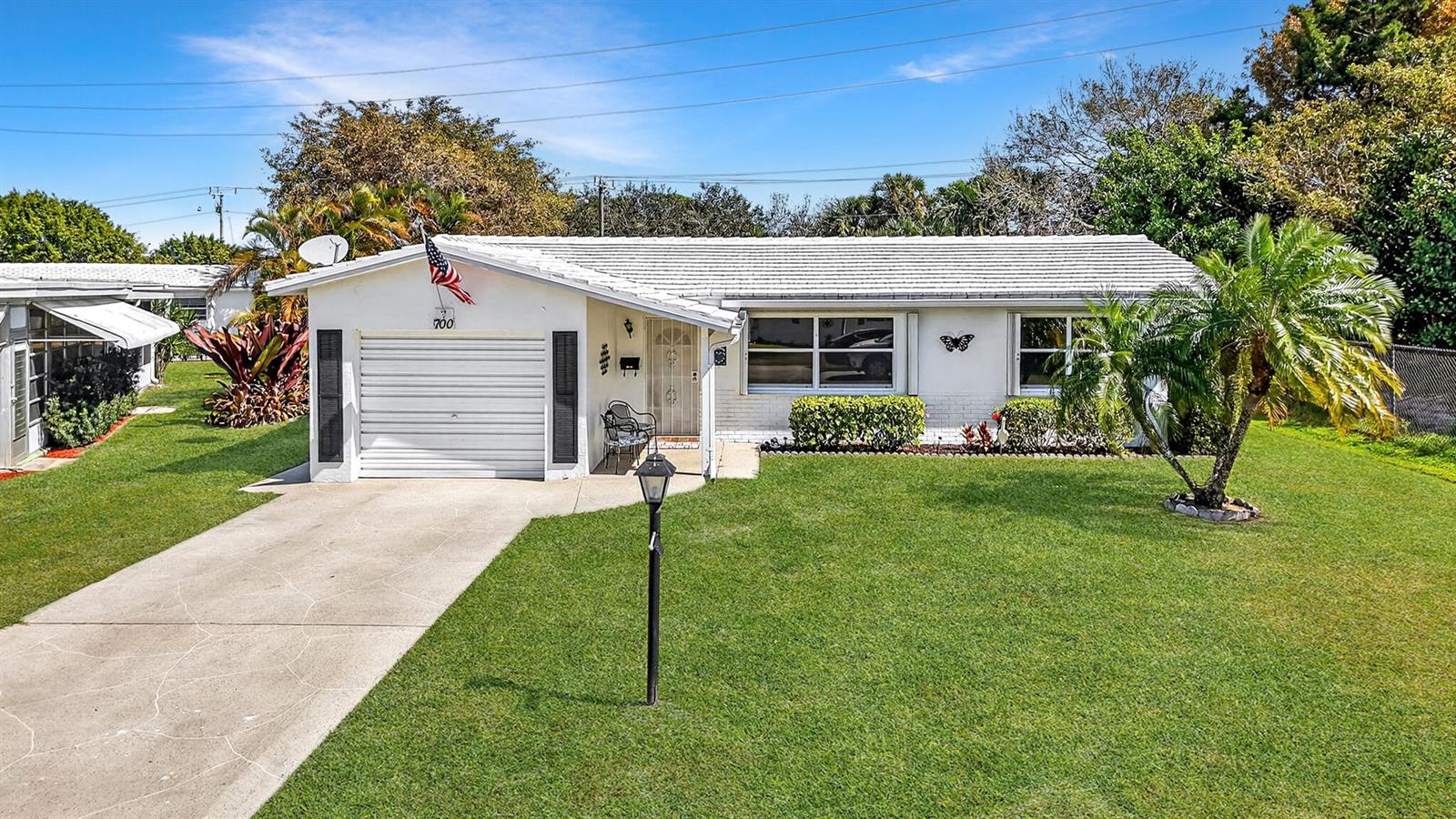 A single-story white house with a garage, front lawn, and a palm tree — 700 Canal Way, Boynton Beach FL 33426, BOYNTON BEACH, FL