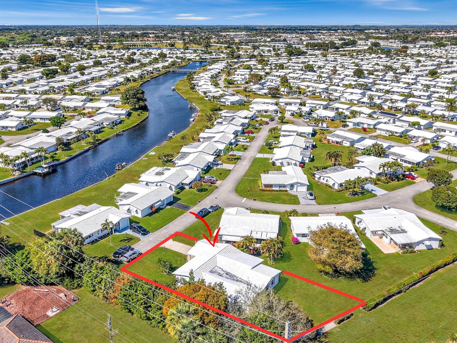 An aerial view shows a white house with a red outline and arrow in a neighborhood — 700 Canal Way, Boynton Beach FL 33426, BOYNTON BEACH, FL