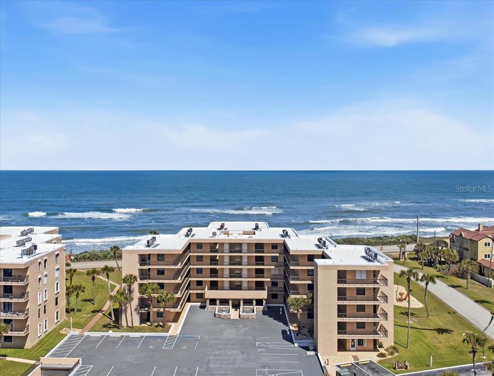 An aerial view of a multi-story beachfront apartment complex with a parking lot — 3360 OCEAN SHORE BOULEVARD UNIT 3070, ORMOND BEACH, FL