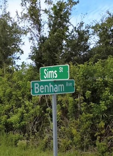A street sign indicates the intersection of Sims Street and Benham Avenue — 4153, 4145, and 4137 SIMS STREET, PORT CHARLOTTE, FL