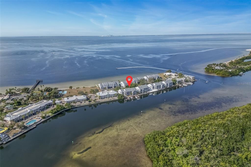 An aerial view shows a waterfront condominium complex on a narrow peninsula — 803 BAHIA DEL SOL DRIVE UNIT B, RUSKIN, FL