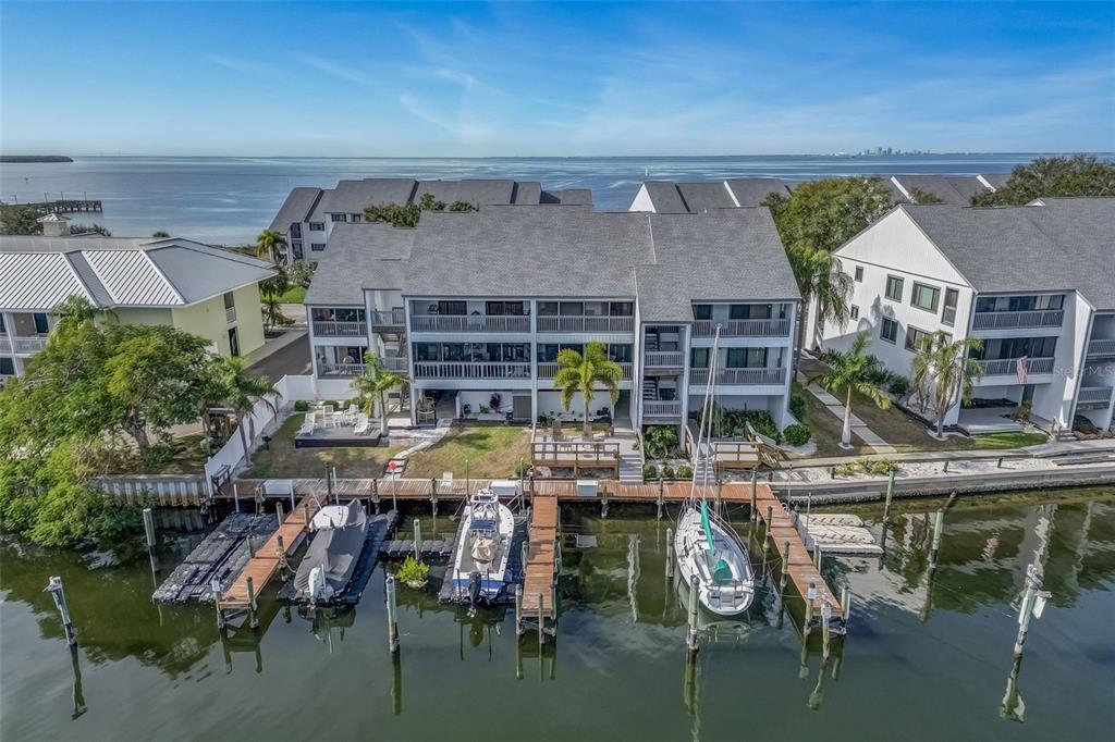 An aerial view of a waterfront condominium complex with boat slips and a private dock — 803 BAHIA DEL SOL DRIVE UNIT B, RUSKIN, FL
