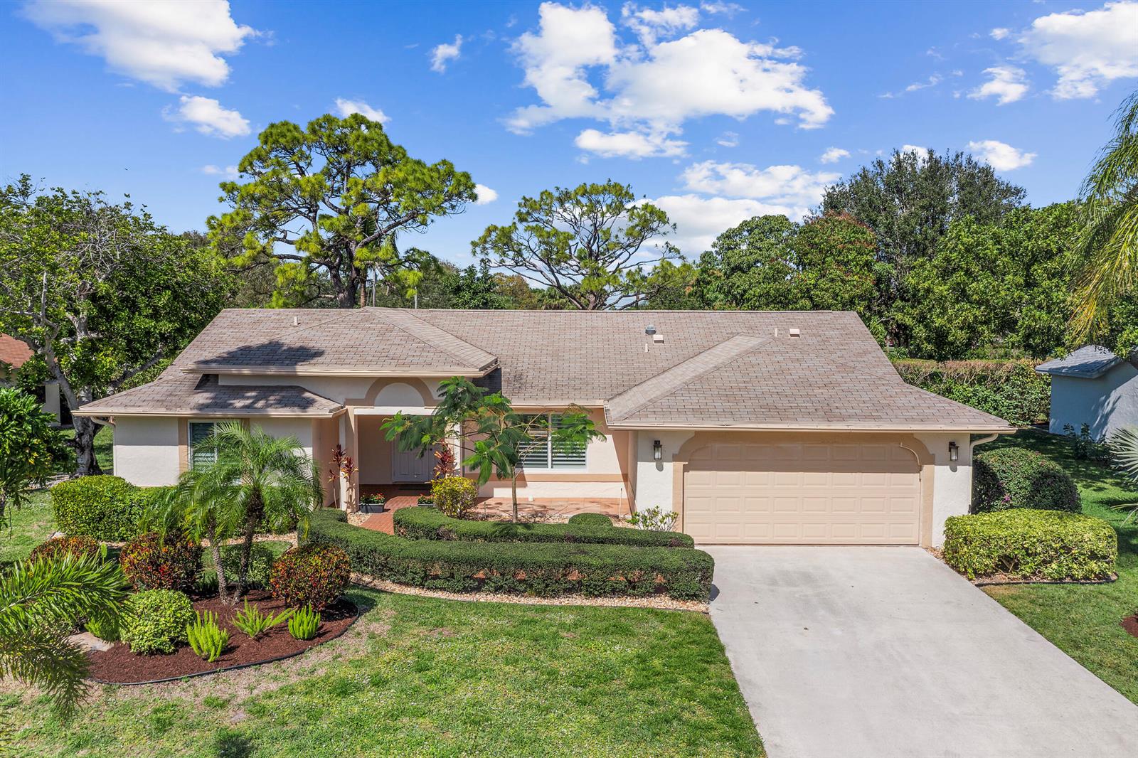 A single-story house with a beige stucco exterior, a shingled roof, and a two-car garage — 2685 Riviera Drive, Delray Beach FL 33445, DELRAY BEACH, FL