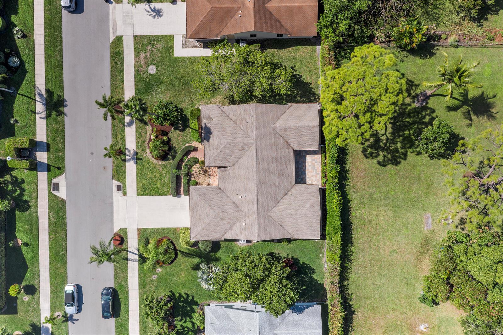 An aerial view shows a residential house with a shingled roof and landscaped yard — 2685 Riviera Drive, Delray Beach FL 33445, DELRAY BEACH, FL