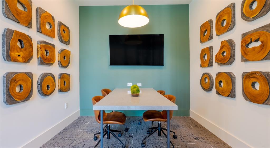 A conference room features a gray table, leather chairs, and wood slice wall art — 18772 GRAND LIVE OAK BOULEVARD UNIT B1.2, LAND O LAKES, FL