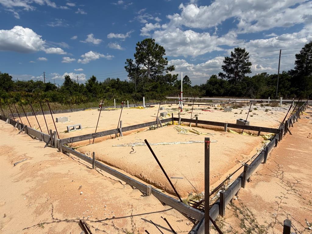 A construction site shows a foundation prepared for a new home with wooden formwork — 7218 SUN N LAKE BOULEVARD, SEBRING, FL