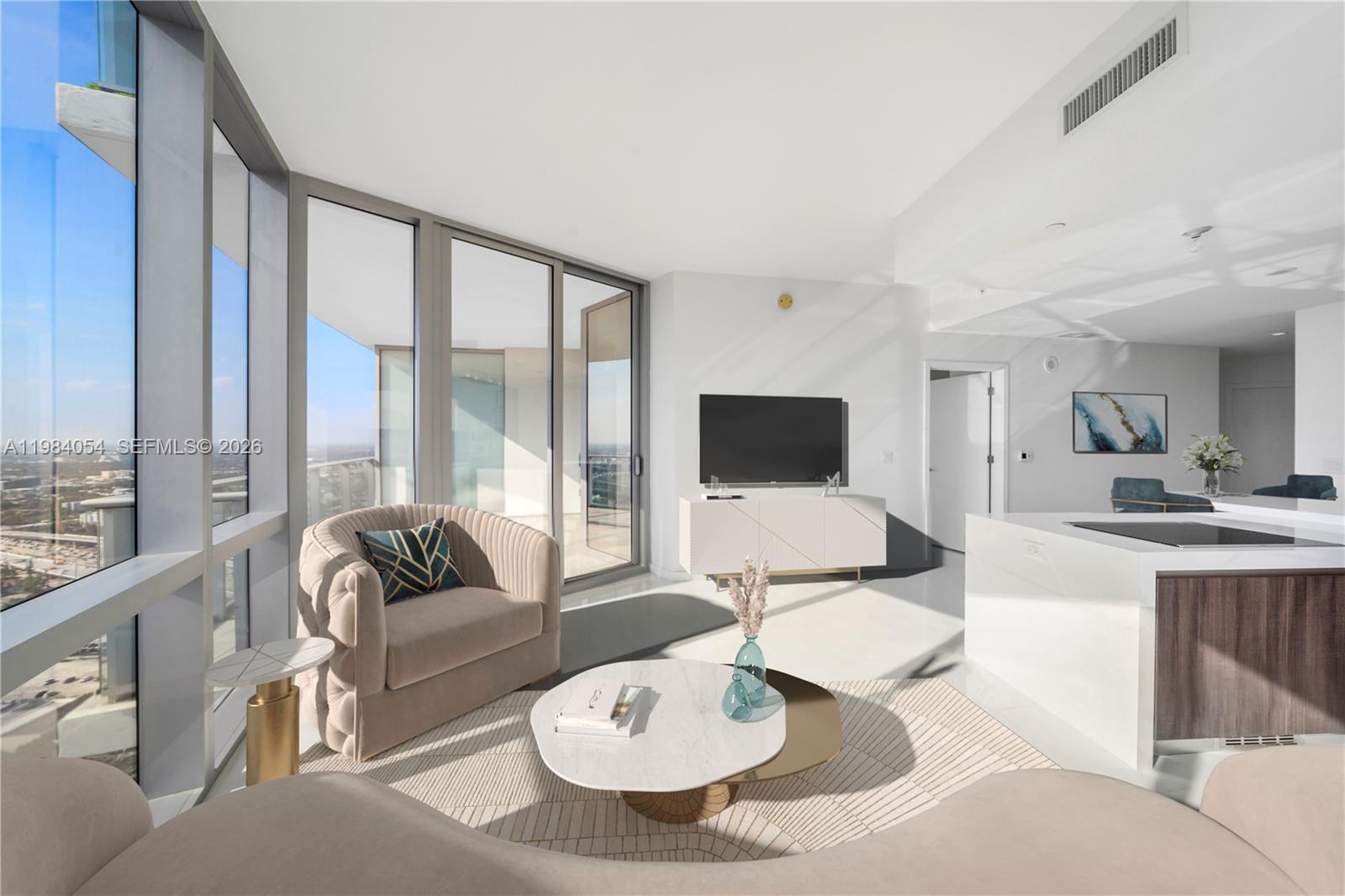 A modern living room features floor-to-ceiling windows, a curved armchair, and a white media console — 851 NE 1st Ave # 4010, Miami FL 33132, MIAMI, FL