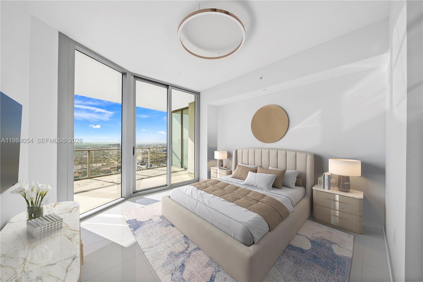A modern bedroom features a platform bed, floor-to-ceiling windows, and a balcony with city views — 851 NE 1st Ave # 4010, Miami FL 33132, MIAMI, FL