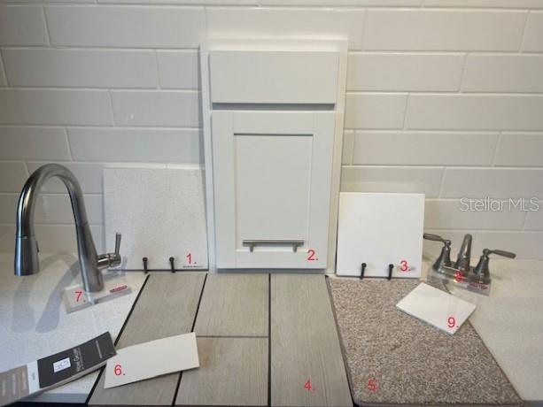 A display of interior design finish samples including cabinetry, flooring, countertops, and plumbing fixtures — 168 FLAG LILLY LANE, UMATILLA, FL