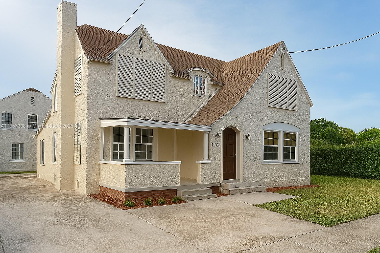 A two-story stucco house with a brown roof, front porch, and concrete driveway — 2619 SW 5th St, Miami FL 33135, MIAMI, FL