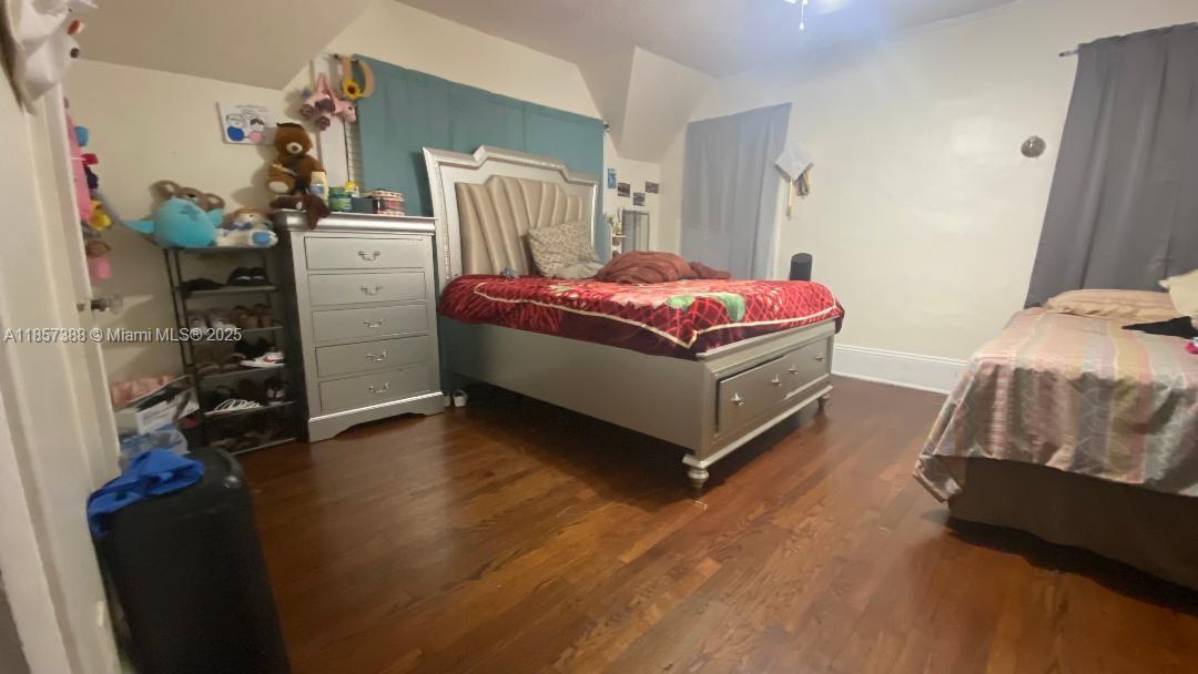 A bedroom features hardwood floors, a silver bed frame, a matching dresser, and two beds — 2619 SW 5th St, Miami FL 33135, MIAMI, FL