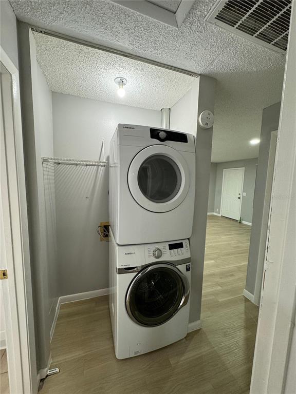 A stacked Samsung washer and dryer unit sits inside a small laundry closet — 2526 ELM AVE, LAKE WALES, FL