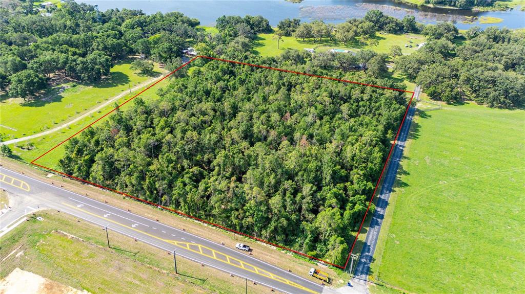 An aerial view shows a rectangular, wooded lot outlined in red next to a paved road — 36126 SAINT JOE ROAD, DADE CITY, FL