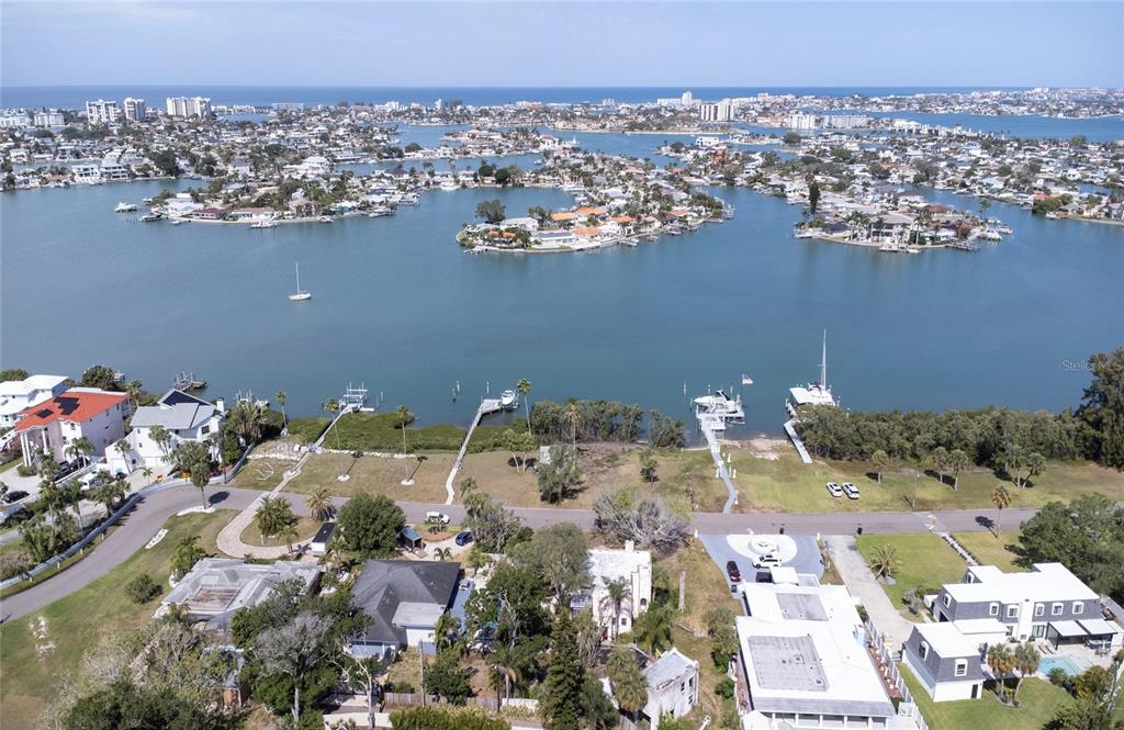 An aerial view shows waterfront homes with private docks along a bay in Florida — 662 VILLAGRANDE AVENUE S, ST PETERSBURG, FL