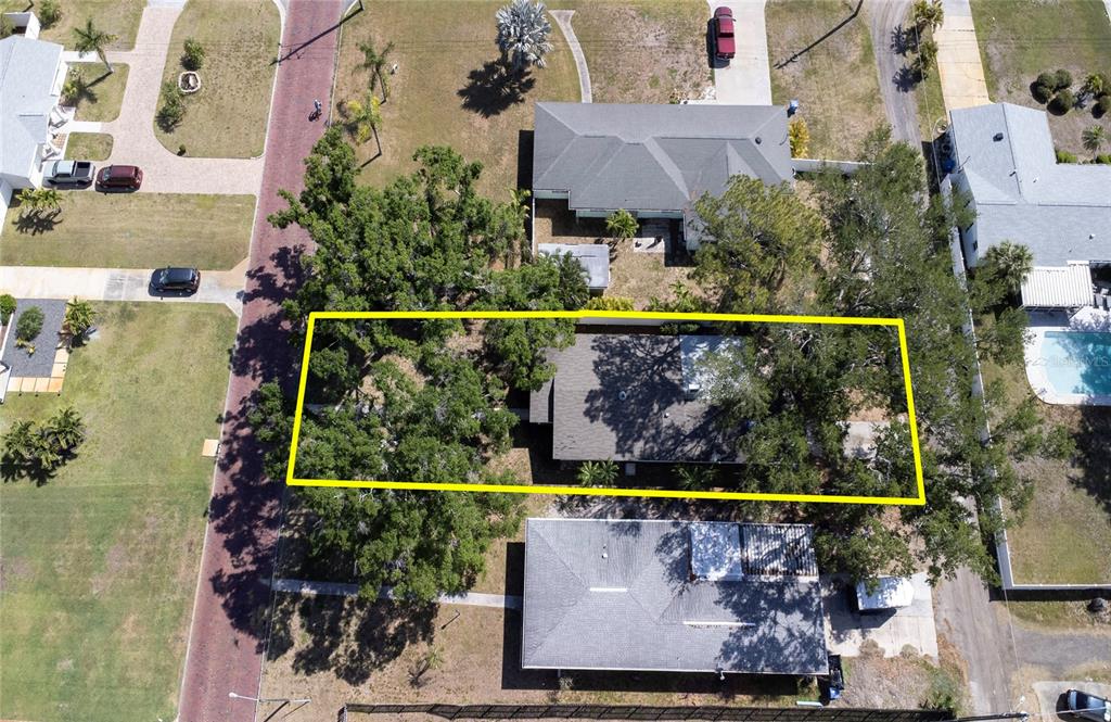 An aerial view shows a residential property with a house surrounded by large trees — 662 VILLAGRANDE AVENUE S, ST PETERSBURG, FL