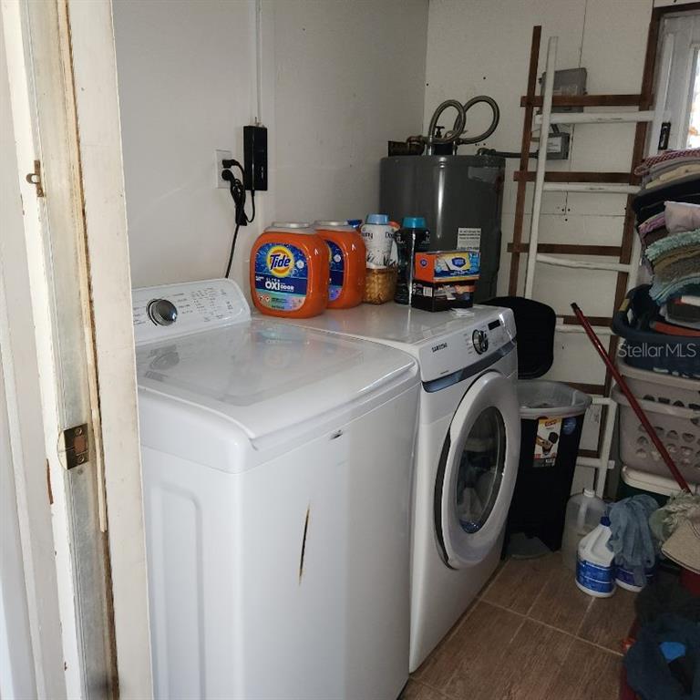 A laundry room features a top-load washer, a front-load dryer, and a water heater — 4070 GROBE STREET, NORTH PORT, FL