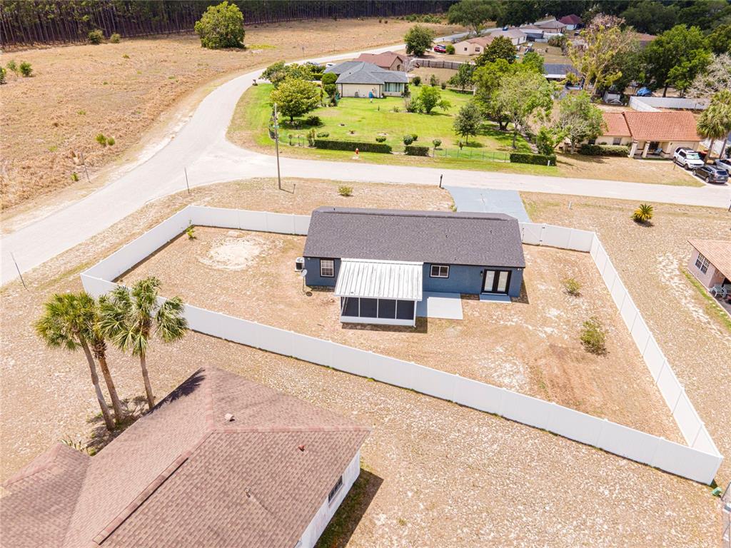 An aerial view shows a house with a fenced backyard and a screened-in patio — 336 OAK TRACK DRIVE, OCALA, FL