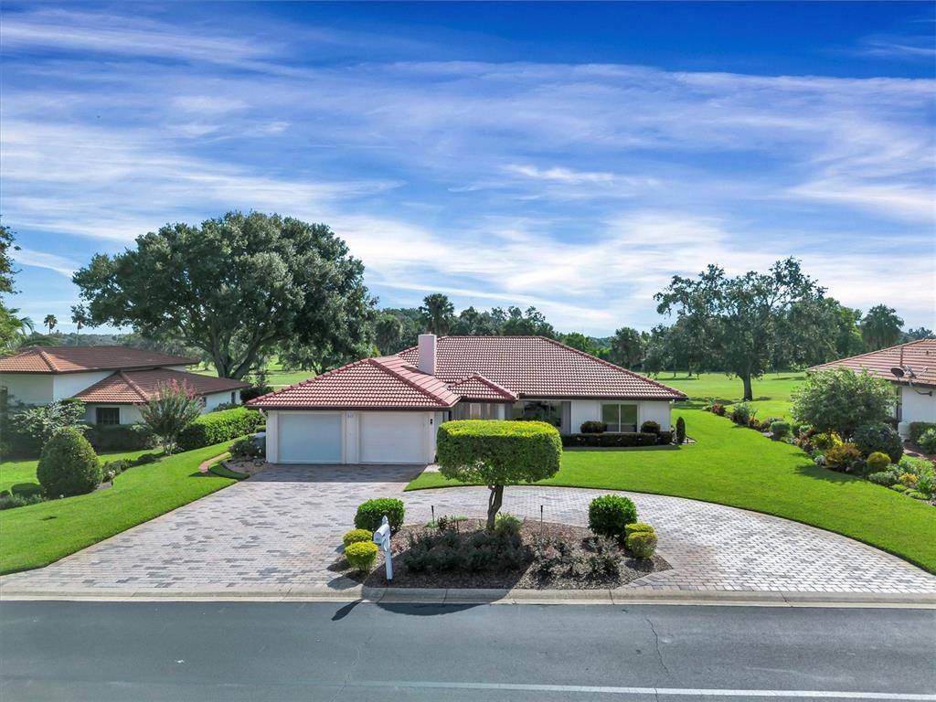 A single-story house with a red tile roof and a paved circular driveway — 517 CLUBHOUSE DRIVE, LAKE WALES, FL