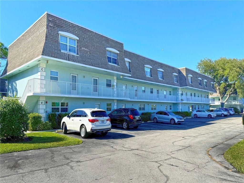 A three-story apartment building with a light blue exterior and a shingled mansard roof — 1901 Indian River Boulevard # 104C, Vero Beach FL 32960, VERO BEACH, FL
