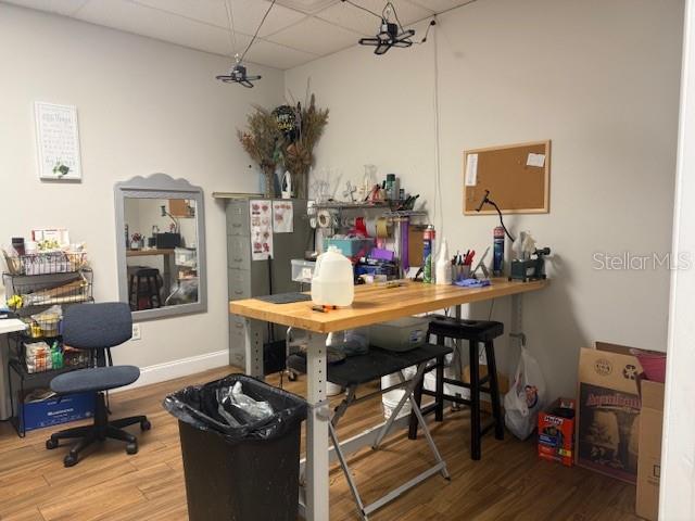 A craft room features a wooden workbench, a rolling office chair, and a wall mirror — 120 ALEXANDRIA BOULEVARD UNIT 17, OVIEDO, FL