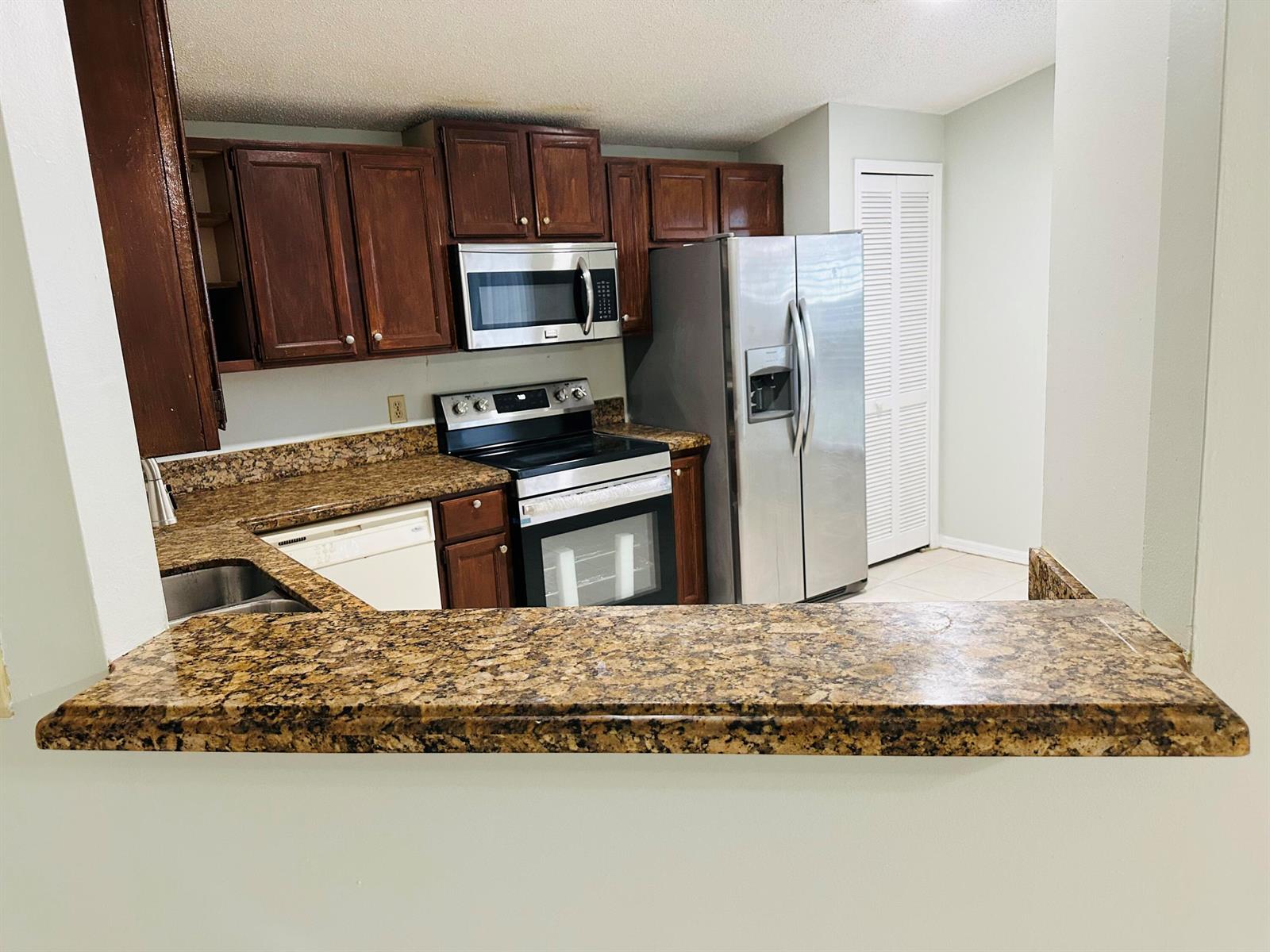 A single-story house with a two-car garage and two vehicles parked in the driveway — 5165 Foxhall Pl, West Palm Beach FL 33417, WEST PALM BEACH, FL