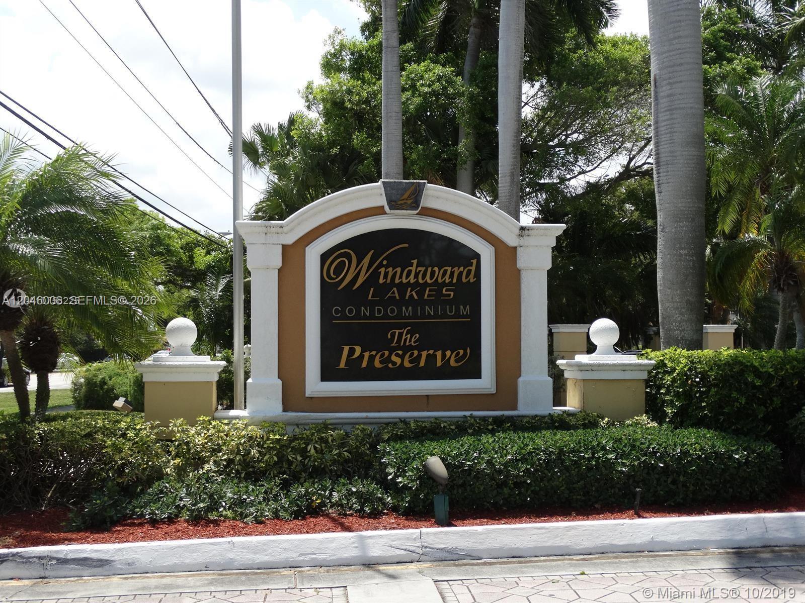 A sign for Windward Lakes Condominium The Preserve stands in front of palm trees — 4015 W Mcnab Rd # D210, Pompano Beach FL 33069, POMPANO BEACH, FL