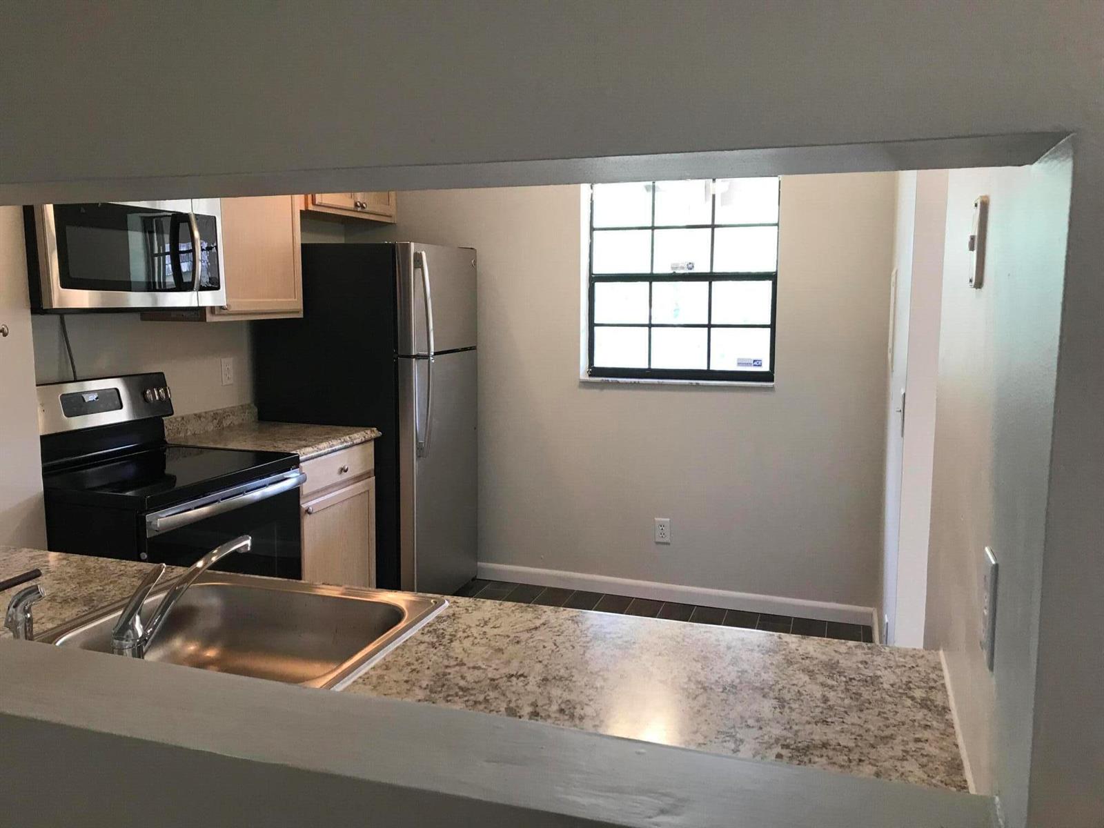 A kitchen with stainless steel appliances, light wood cabinets, and granite-style countertops — 3629 NW 94th Avenue # 5g, Sunrise FL 33351, SUNRISE, FL