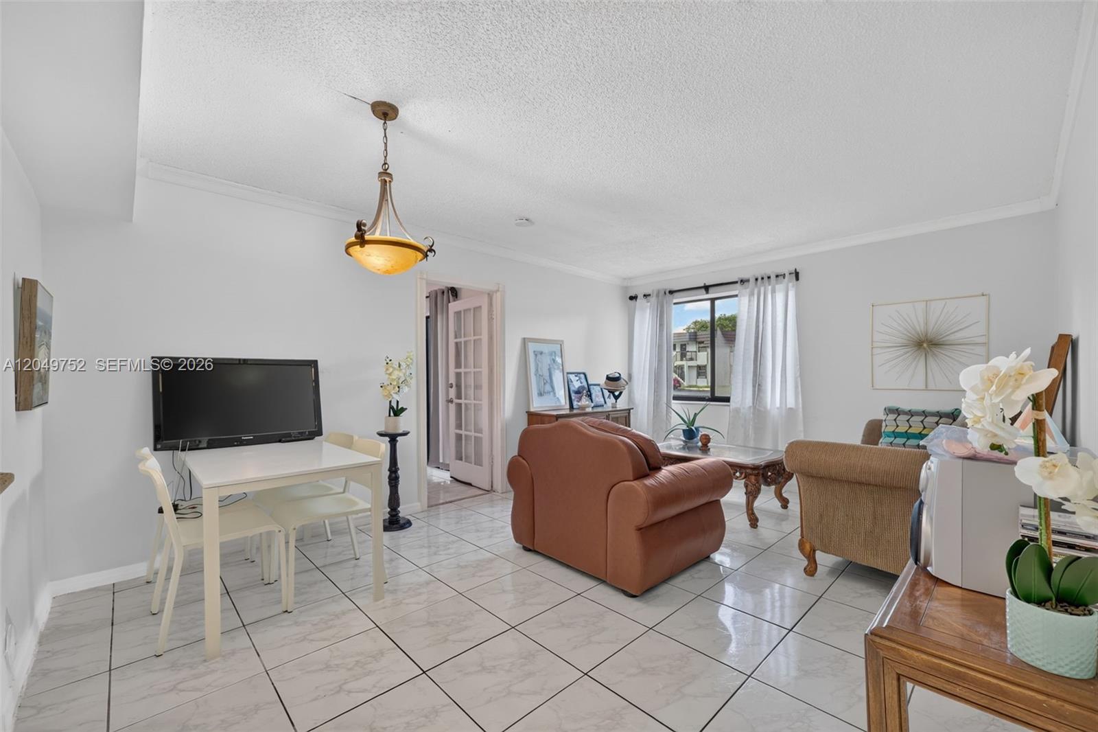 A living room with white tile floors, a dining area, and brown upholstered furniture — 14929 SW 104th St # 14, Miami FL 33196, MIAMI, FL