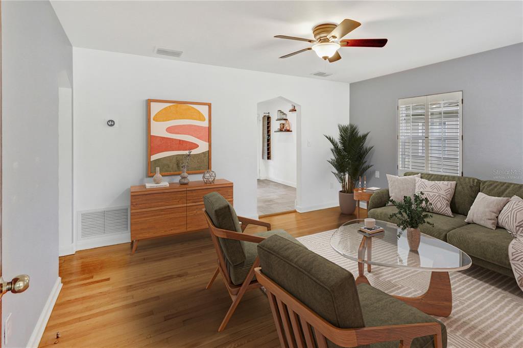 A living room features hardwood floors, a green sofa, two armchairs, and a ceiling fan — 1016 W SMITH STREET, ORLANDO, FL